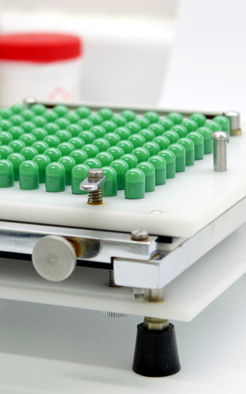 Scientist looking through microscope in laboratory